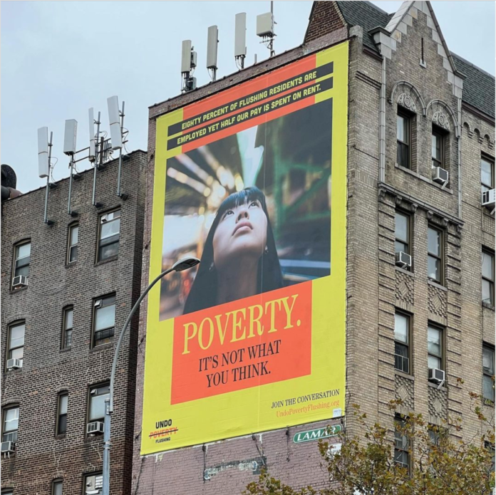 A billboard in Flushing, Queens, New York, reads: Poverty. It's not what you think